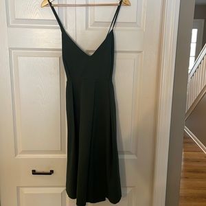 Green dress. Perfect for wedding guest. Has pockets! Criss cross back detail